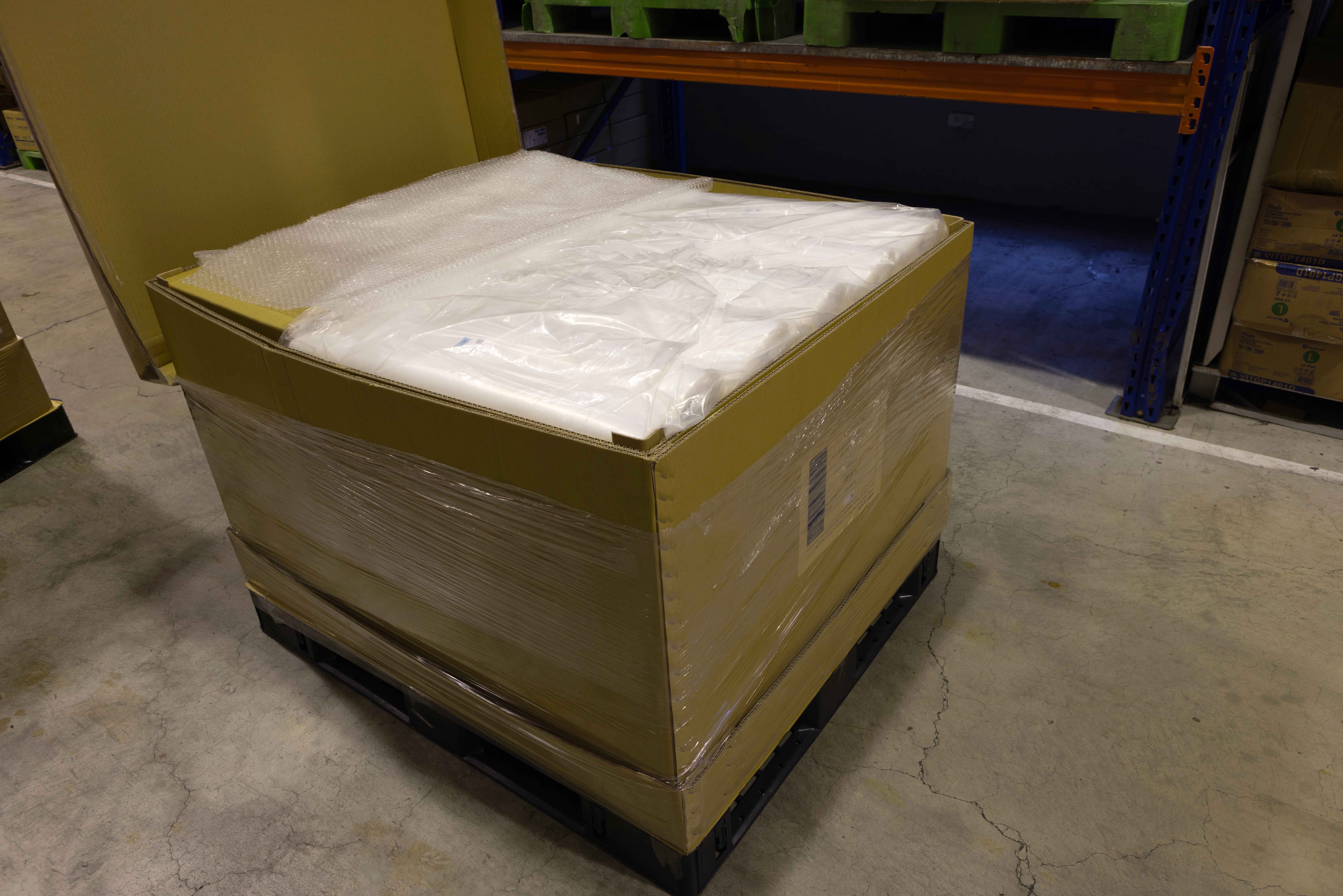 Workers performing bulky packaging operations